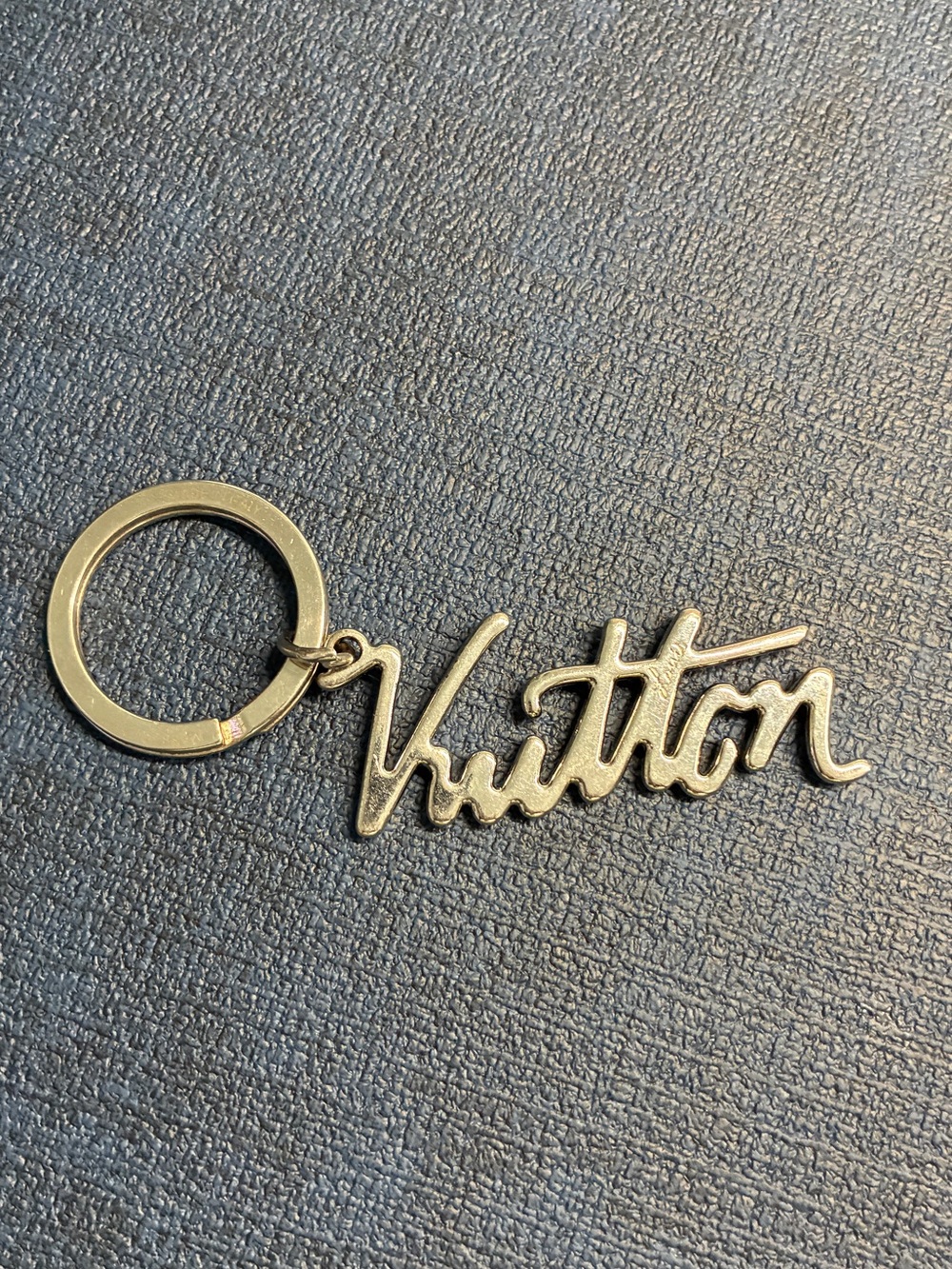 LOUIS VUITTON SIGNATURE GOLD-TONE KEYCHAIN